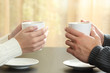 © Antonioguillem - Hands of couple with coffee cups