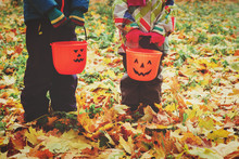 Little Boy And Girl Trick Or Treating In Fall Nature