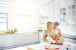 © Flamingo Images - Mother kissing her daughter in kitchen