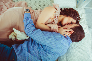 Wall Mural - Tender kiss of stunning couple waiting for a child