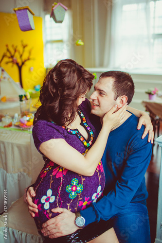 Tender Pregnant Woman In Violet Dress Sits On Her Mans Knees Stock