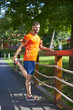 © sepy - Fit runner man outdoor. Full length shot of young man at park after running relaxing and stretching.