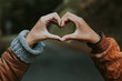 © carballo - hands linked with heart sign outdoors