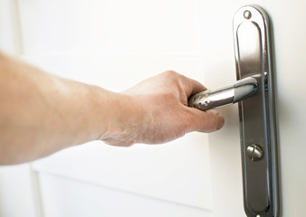 The process of clicking on the handle to open the door