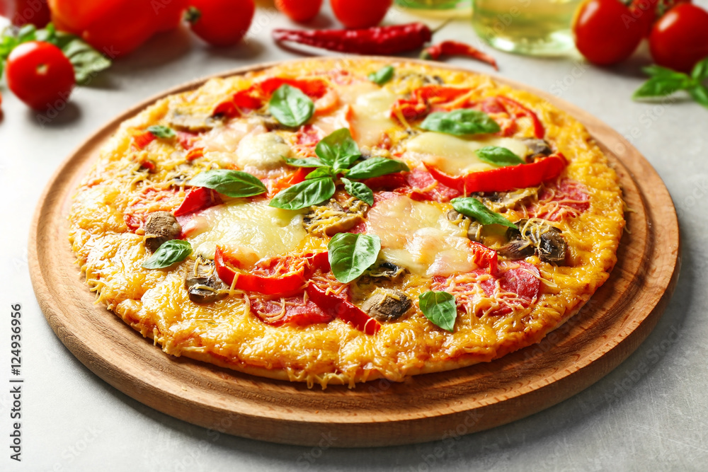 Tasty pizza with ingredients on table