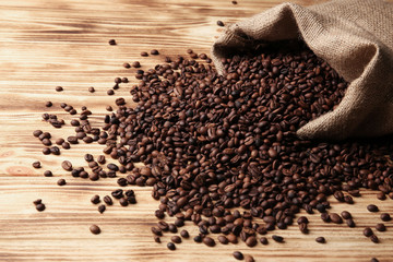  Coffee beans and sack on wooden background