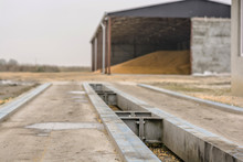 Trucking Weigh Station With Grain Tank In Background