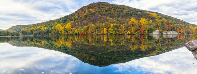 Wall Mural - Lake at Bear Mountain in New York State in the autumn season during peak foliage with a clear reflection in the water