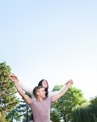 happy couple in park with copy space at sky