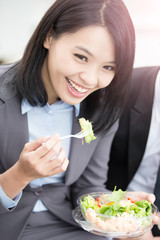 Wall Mural - businesswoman eat salad in office