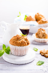 Wall Mural - Delicious homemade coconut cinnamon muffin on marble coasters. Healthy food concept.