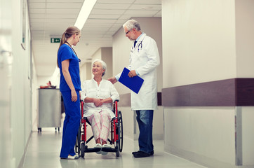 Poster - medics and senior woman in wheelchair at hospital