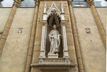 Marble statue of Saint Philip (Guild of Shoemakers) by Nanni di Banco, detail of Orsanmichele church exterior with 1 of 14 external niche figures in Florence, Italy