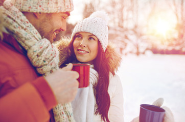 Wall Mural - happy couple with tea cups over winter landscape