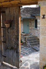 Wall Mural - Old door and traditional architecture in the stone village of Papigo in Epirus, Greece