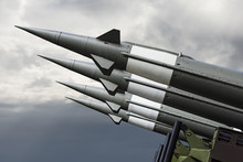 Nuclear Missiles With Warhead Aimed At Gloomy Sky. Balistic Rockets War Backgound.