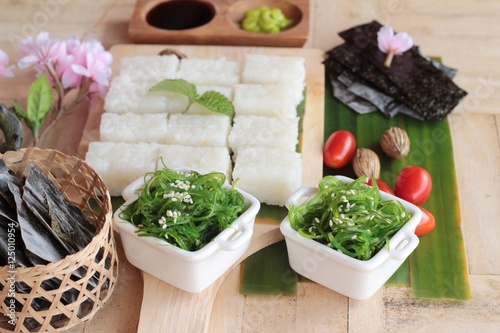 Making Sushi Roll And Seaweed Salad With Rice Buy This Stock
