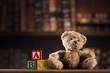 Teddy bear on on vintage wooden background