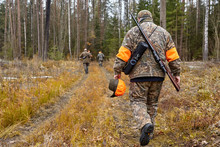 Group Of Hunters In Forest