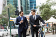 © Sergey Nivens - Young businessmen with a bike