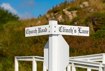 Wooden post with white street signs