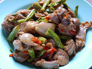 Fried basil leave with chicken innards on plate,spicy