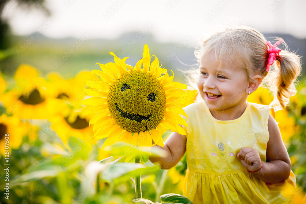 beautiful little girl in sunflowers Stock Photo | Adobe Stock