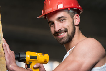 Worker Drilling A Large Wood Plank