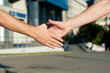 © mikhasik - men shaking hands on building background