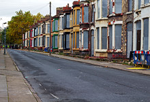 A Street Of Boarded Up Derelict Houses Awaiting Regeneration In Liverpool UK