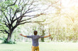© zoneteen - Happy Young Man with Hands Up on the Nature Background
