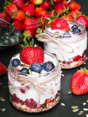 Wall Mural - delicious dessert - yogurt with strawberries and blueberries