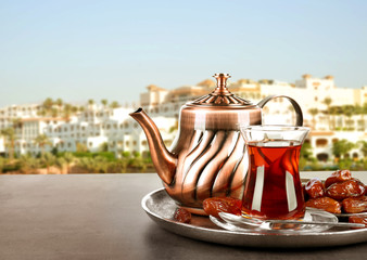 Composition for Turkish tea ceremony on table against cityscape background. Culture heritage concept.