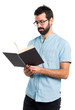 © luismolinero - Handsome man with blue glasses reading book