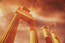 Ancient Greek Columns On A Background Of Orange Sunset Sky