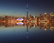 Toronto Skyline at night with a reflection in Lake Ontario. 