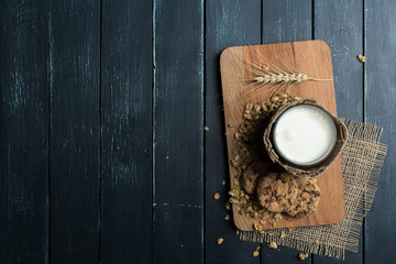 Glass of milk on table on blurred natural background