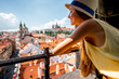 Young female tourist enjoying great view on the old town of Prague