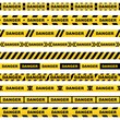 Set of yellow ribbons with black lettering danger skull and stripes indicating dangerous place on a white background. Safety police warning tapes