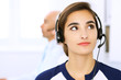 © rogerphoto - Call center. Focus on beautiful woman in headset