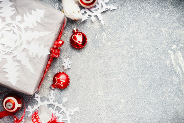 Christmas background with white red gift wrap and festive holiday decorations, top view, border