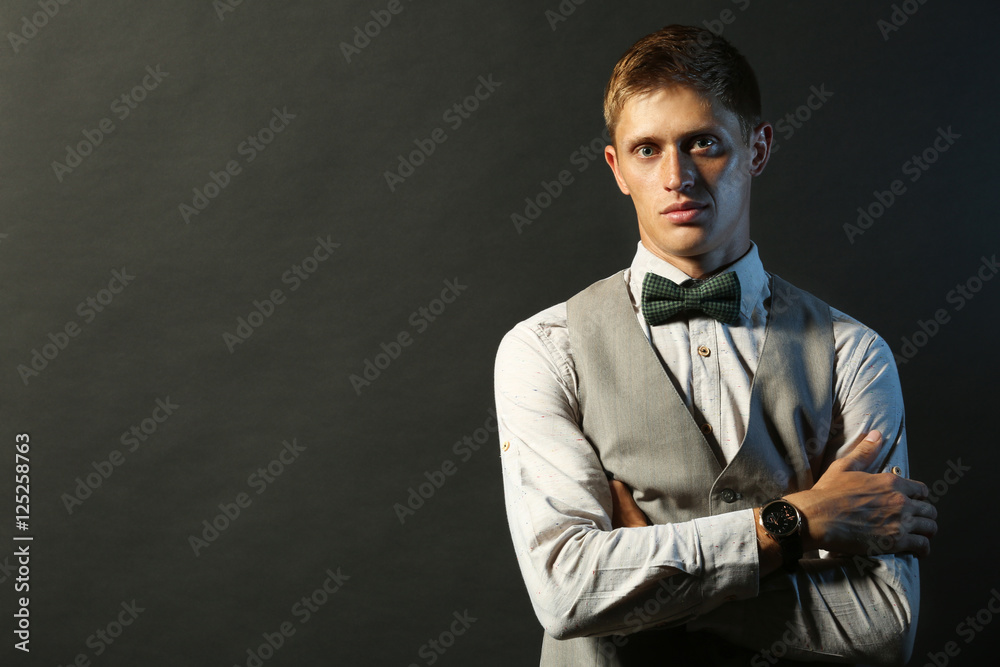 Portrait of elegant man on dark background