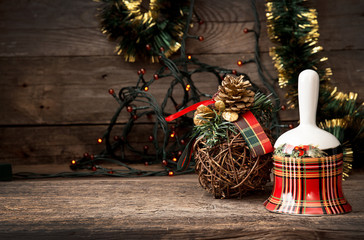 Christmas checkered bell on wooden table against background Chri