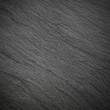 © jamroenjaiman - Dark grey black slate background or texture.