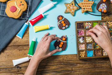 Wall Mural - Artisan woman decorating Christmas cookies