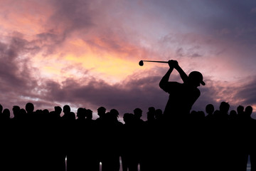 Golfer playing golf during sunset at competition event