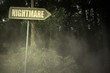 old signboard with text nightmare near the sinister forest