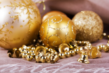 Festive gold Christmas decorations on fabric background