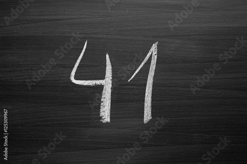 Poster number forty one enumeration written with a chalk on the blackboard