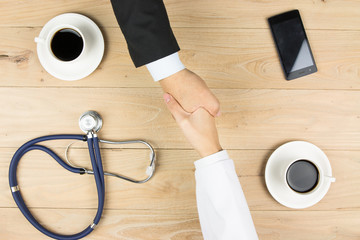 Wall Mural - Doctor and businessman shaking hands